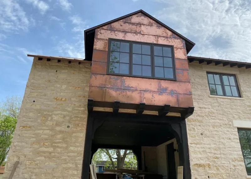 Copper metal panel facade on a stone building for Skylight Installation in Abilene